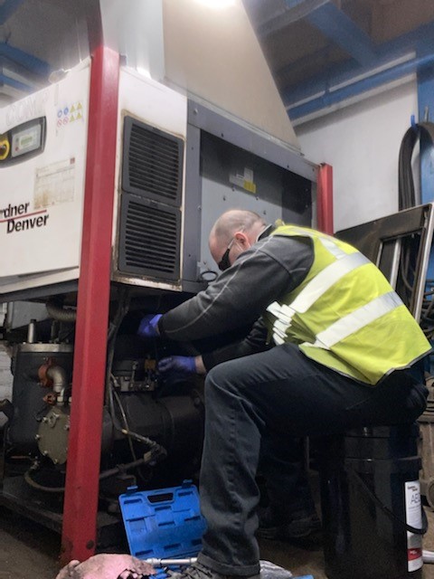 Airmac employee glen providing maintenance to a Gardner Denver air compressor